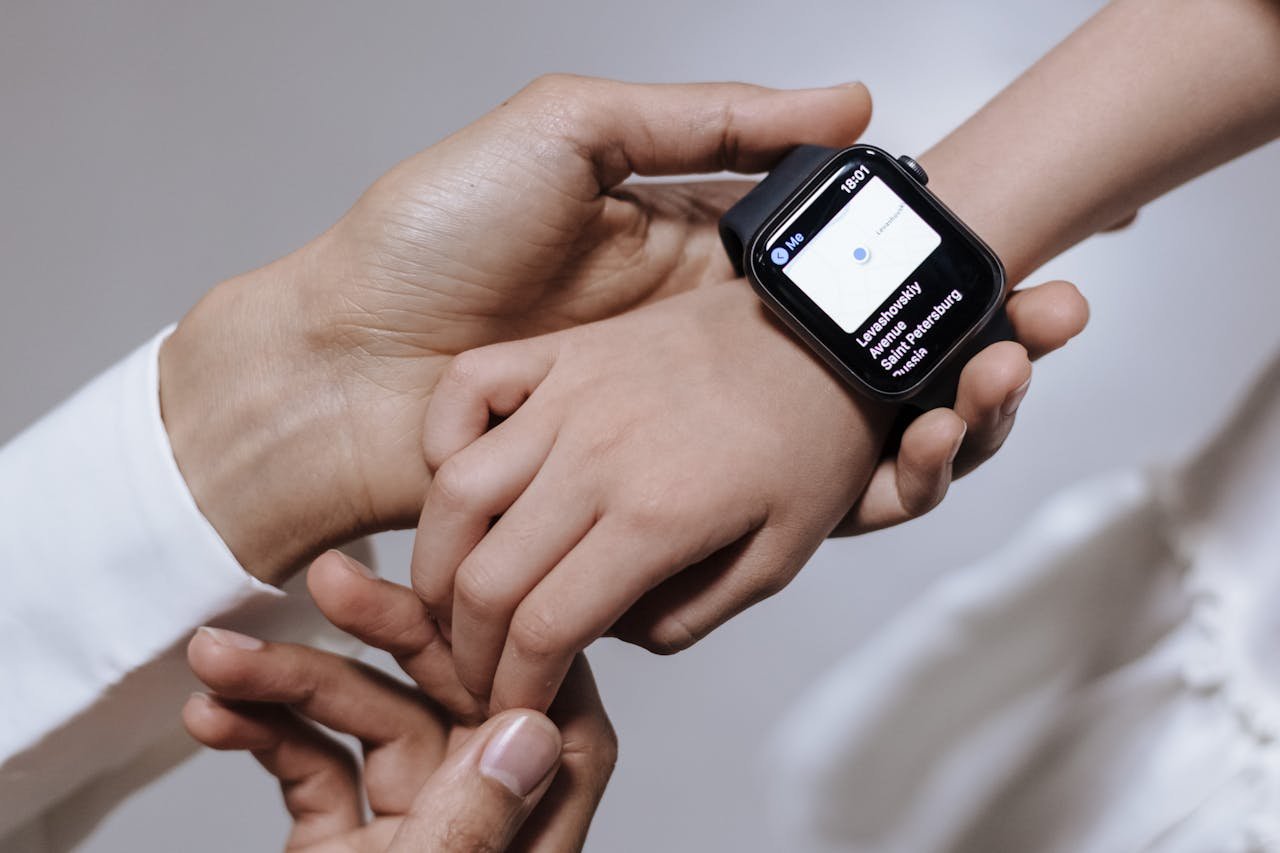 creative Close-up of a mother assisting her daughter with a smartwatch, emphasizing family care and technology.